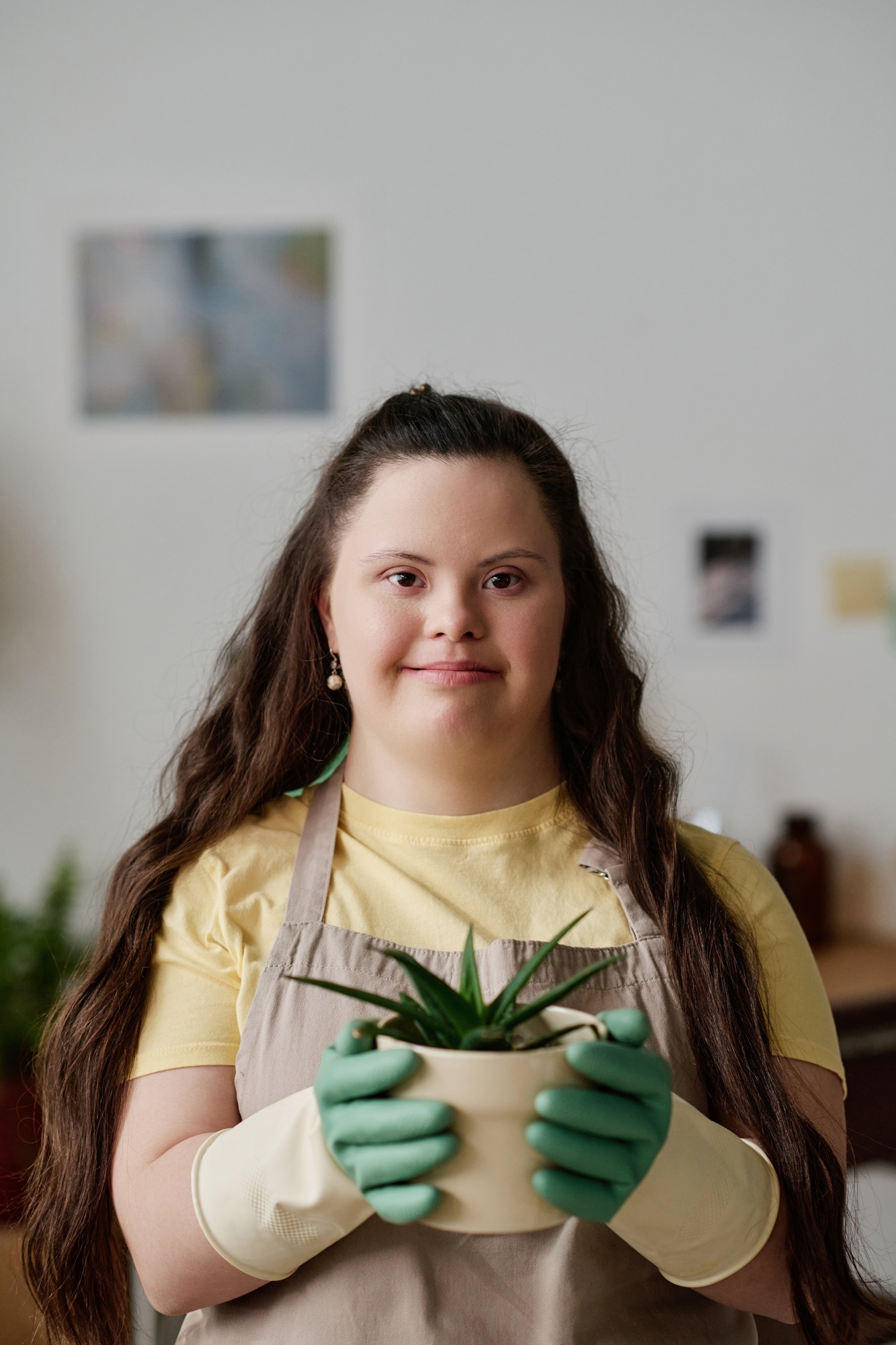 Girl with down syndrome caring about green plants